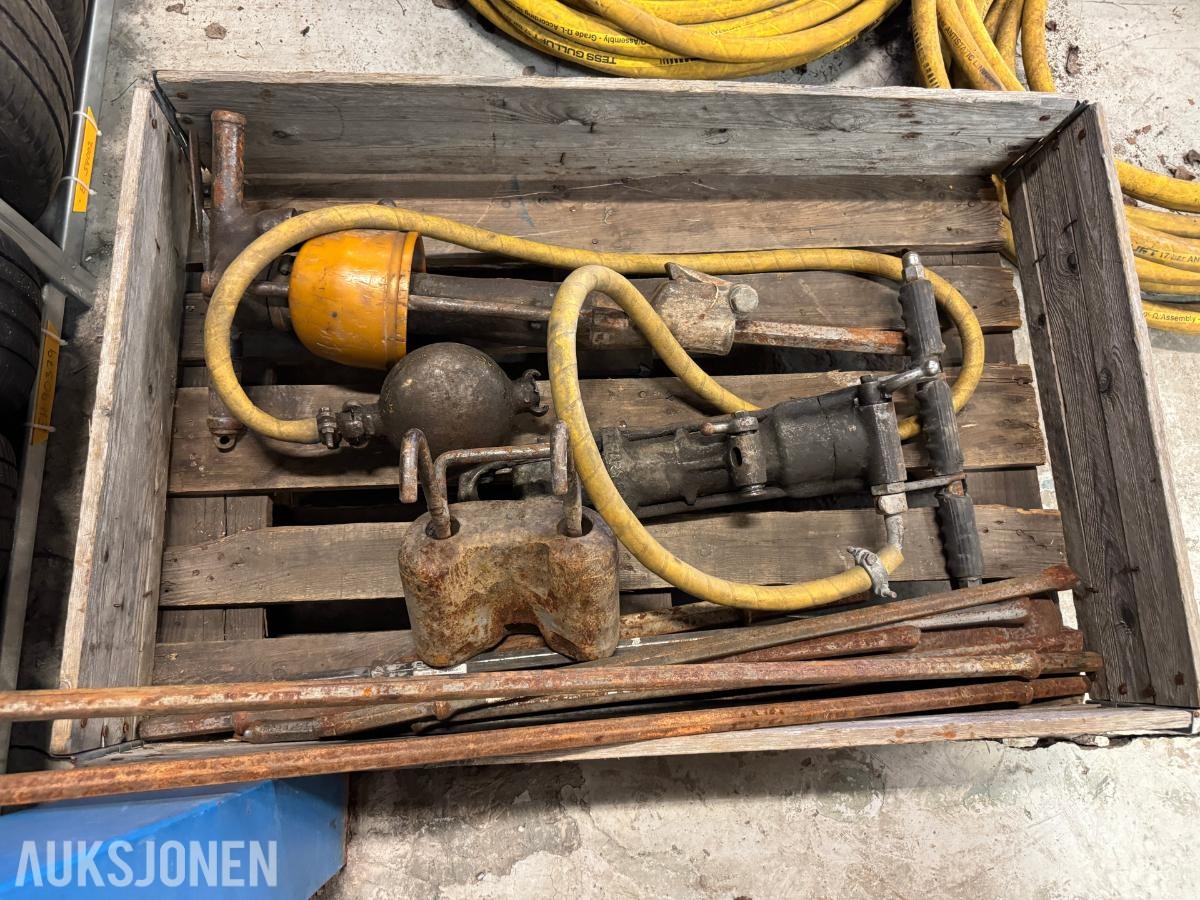 Diverse bergboreutstyr med borestenger og slanger