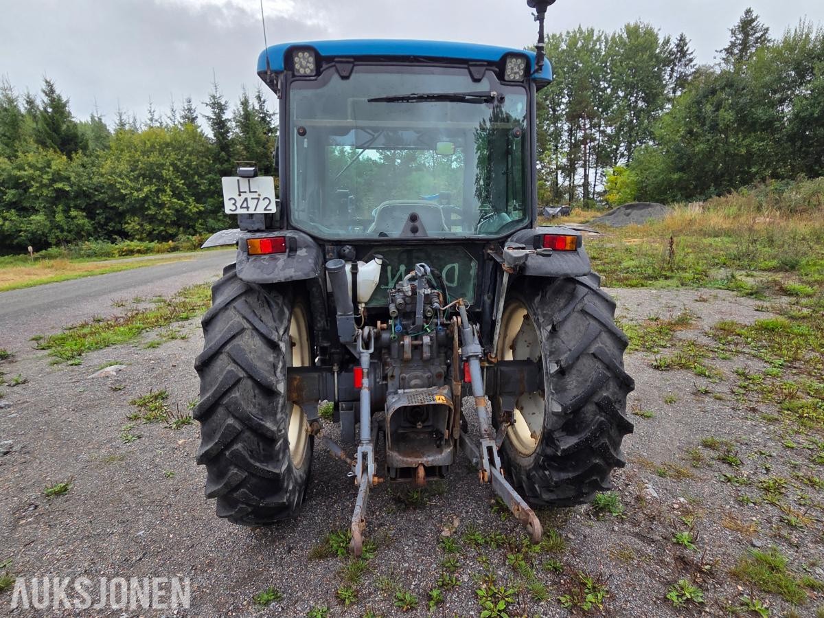 2000 New Holland TN65D med Trima 310C frontlaster