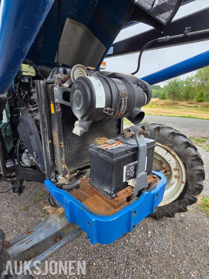2000 New Holland TN65D med Trima 310C frontlaster